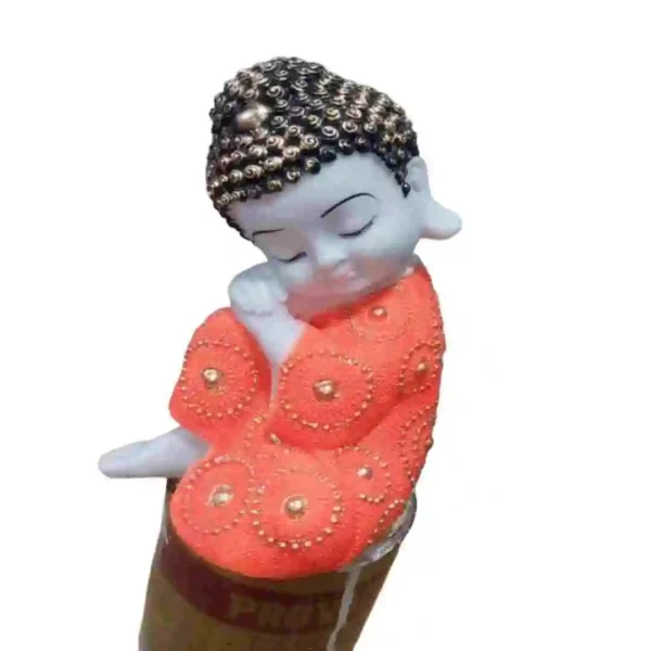 Cute sleeping baby Buddha idol in orange robe made from marble dust – perfect for home decor or gifting